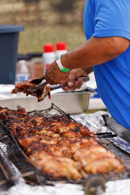 Man cooking BBQ at the Koloa Plantation Days park event