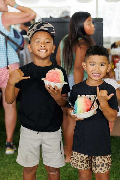 Two small boys with shave ice enjoy the Koloa Plantation Days Park Event in 2025